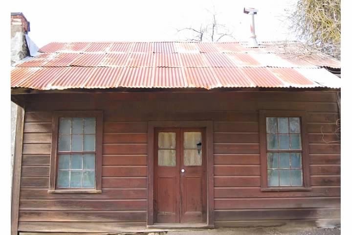 The old post office shown here sits next to a livery building.